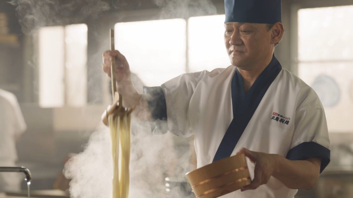 茹で上がった麺を釜からすくい上げる麺職人